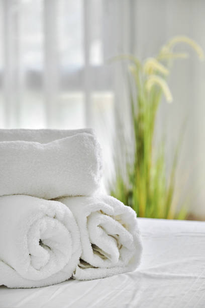 Nurse take care senior man in the bedroom. She bring him to the bed. Home healthcare concept.