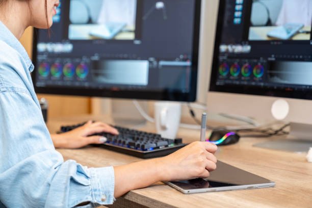 istock young woman working independently, editing a video at home 1950069462
