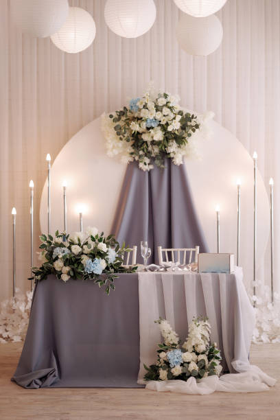 istock Elegant wedding table setup with floral arrangements 1950105775
