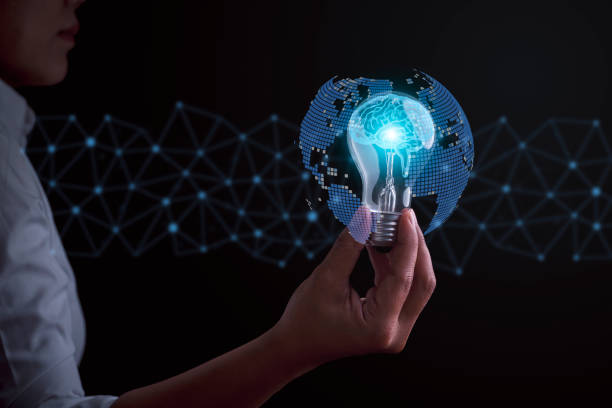 istock Businesswoman holding a glowing light bulb with a brain drawing, symbolizing innovation, creativity, and global connections. Ideal for concepts around strategic thinking and idea development. 1950142281