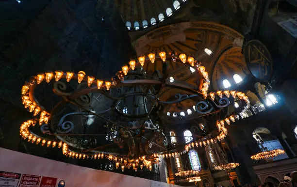 Grand Chandeliers inside the entrance of the Hagia Sophia - landmark byzantine church built by Justinian in 537 AD in Istanbul, Turkey