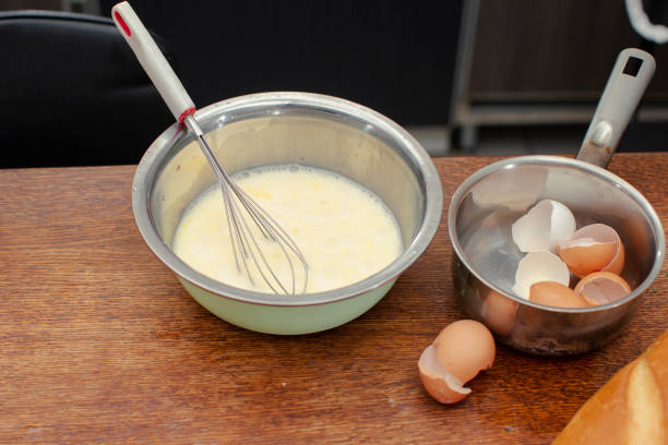istock In a bowl there is a mixture for making an omelet and shells for eggs. 1950162634