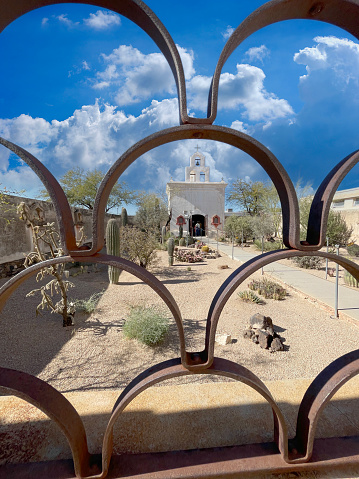 Tucson, AZ, USA - January 18, 2024: The chapel behind the metal railings at the San Xavier del Bac Mission in Tucson AZ