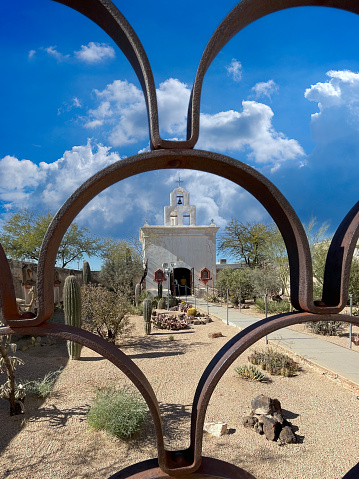 Tucson, AZ, USA - January 18, 2024: The chapel behind the metal railings at the San Xavier del Bac Mission in Tucson AZ