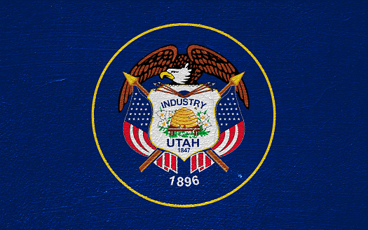 Flag of Utah USA state on a textured background. Concept collage.
