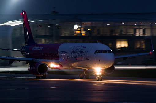 Hungarian low-cost airline's WizzAir Airbus A321 taxiing for takeoff from Lviv Airport at night