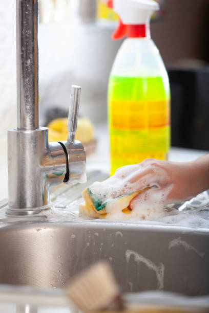 istock Cleaning the sink with a sponge and spray 1950209750