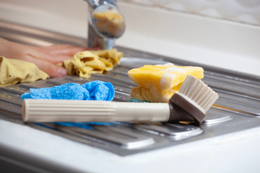 Yellow sponges, dishwashing gel and brush