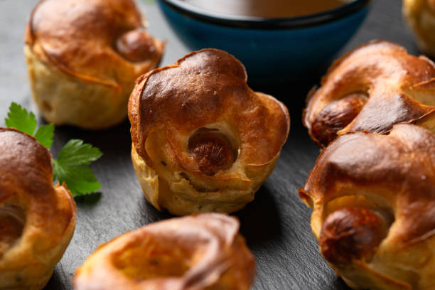 istock Mini Toad in the hole, Baked sausages in Yorkshire pudding with gravy 1950216560