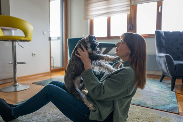 istock Woman having fun with her dog at home 1950228169