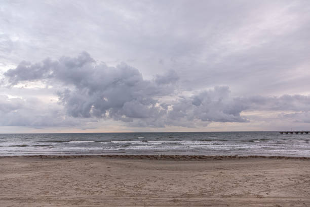 dark clouds at the sandy beach in Galveston, Texas, USA