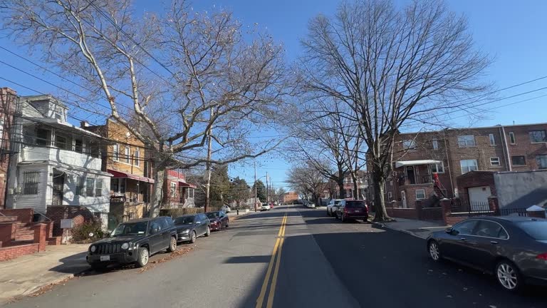 Car Point of View Shot of Multi-Family Townhomes in East Bronx, New York on a Clear Day