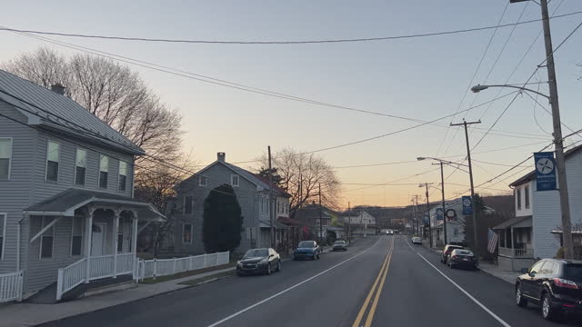 Forward Moving Car Point of View of an Old Town Road Lined with Houses and Businesses in Shartlesville, Pennsylvania on a Clear Evening after Sunset