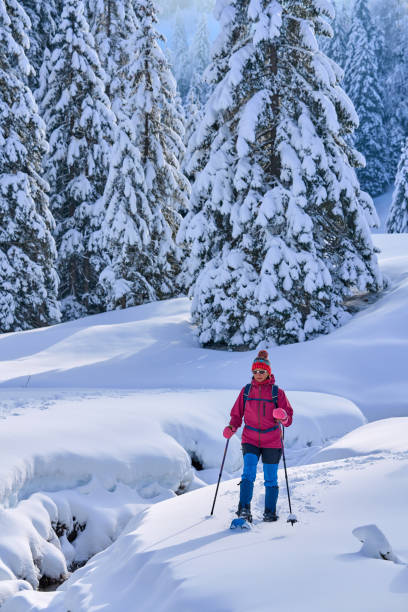 woman with snowshoes in the Bregenz Forest, Austrian Alps