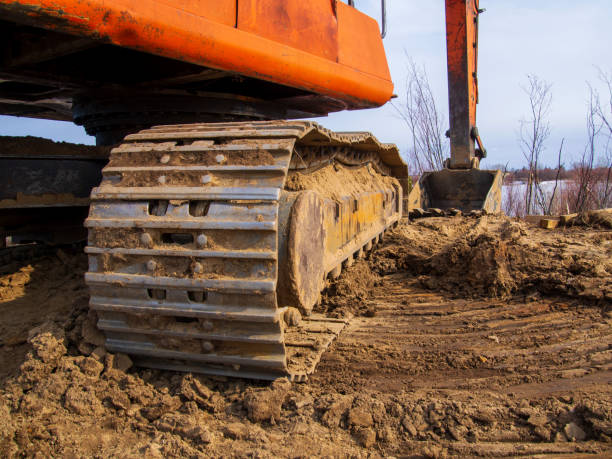 istock Powerful orange excavator in rural area 1950270821