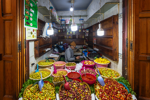 Fez, Morocco – January 01, 2024: A market stall selling pickled olives preserved in olive oil, in Fes el Bali
