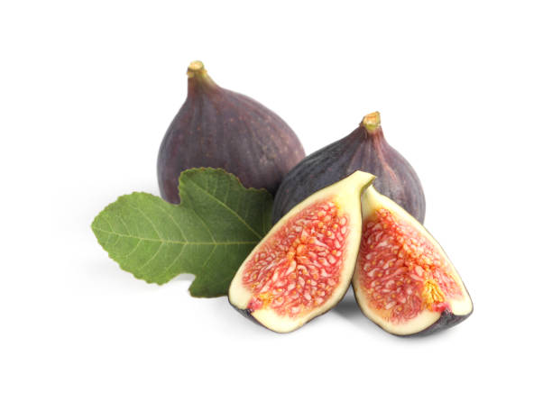 istock Cut and whole ripe figs isolated on white 1950287196