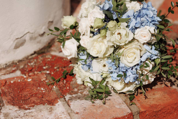 istock Festive wedding bouquet tied with a ribbon on a brick background. 1950306821