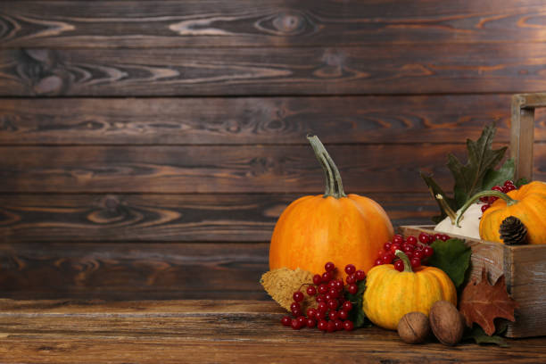 istock Happy Thanksgiving day. Composition with pumpkins, berries and walnuts on wooden table. Space for text 1950310542