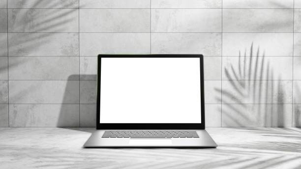 istock Laptop mock up, laptop with white blank empty screen place for design and advertisement on the white cement platform and gray cement tile wall, white screen for design and products, laptop on table 1950328855