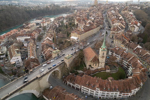 Aerial view of Bern City with church steeple, river and bridge in the late afternoon  in winter