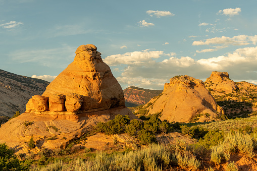 Eroded sandstone pyramid and domes illuminated by the soft sunset light, Elephant Toes Butte, Dinosaurs NM, Utah