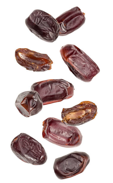 istock flying fresh date fruits isolated on white background. clipping path 1950361717