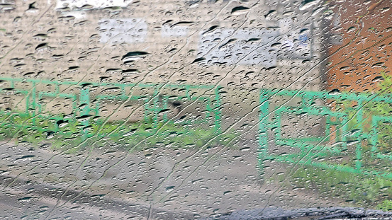 Raindrops on a car window on a spring day.