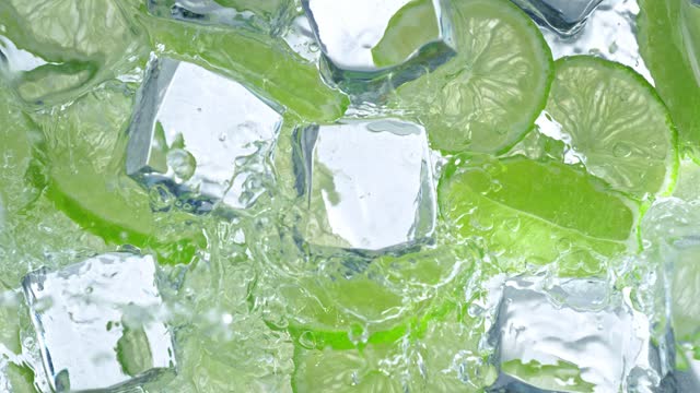 Super Slow Motion Shot of Water Wave Splashing on Lime Slices and Ice Cubes at 1000fps.