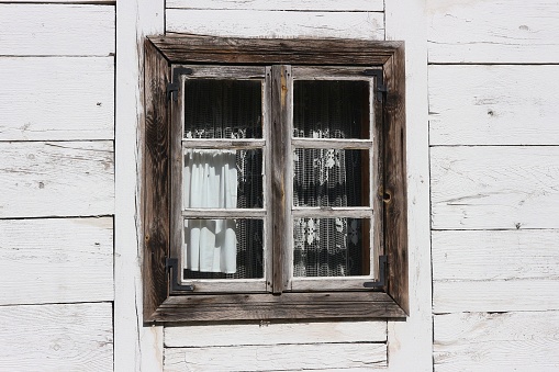 Window in an old wooden cottage in Kujawy, Poland.