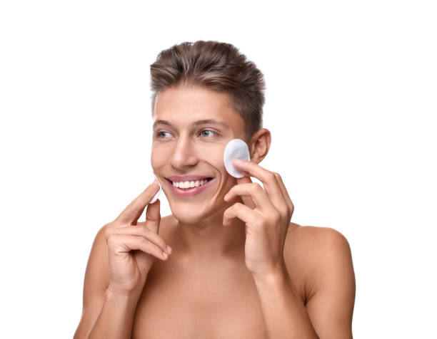 istock Handsome man with cotton pads on white background 1950440577