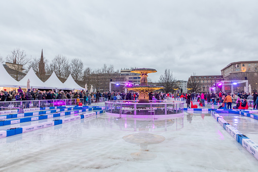 Wiesbaden, Germany - December 29, 2023: people enjoy the rink in front of the kurhaus in Wiesbaden, Hesse, germany.