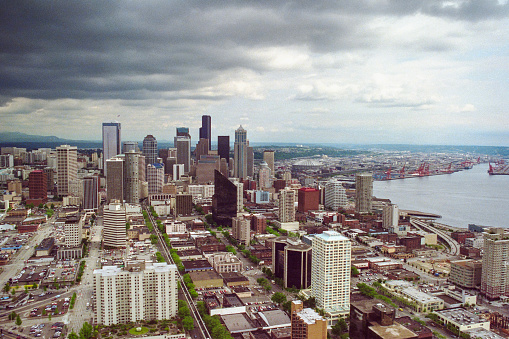 Grainy 1992 film photograph of rainy downtown Seattle Washington buildings and pacific ocean waterfront.