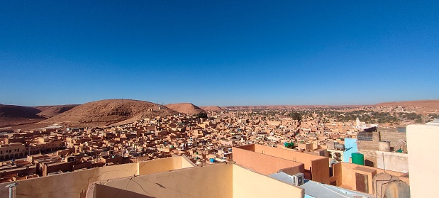 Panoramic view of the city of Ghardaïa from the highest of LES KSOURS DU M’ZAB. With its houses made of clay and stones, typical sub-Saharan desert architecture, Ghardaïa, Oasis M'zab, Algeria