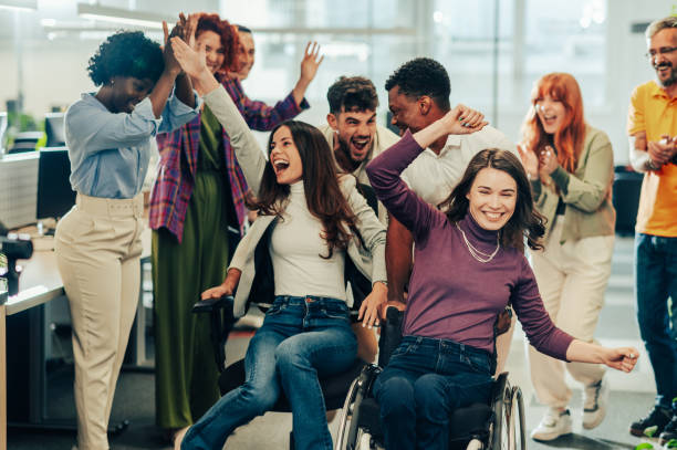istock Diverse inclusive business people making a break while office chair racing 1950525689