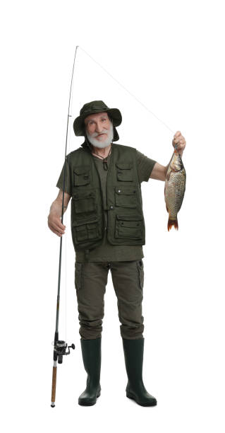 istock Fisherman with rod and catch isolated on white 1950526765