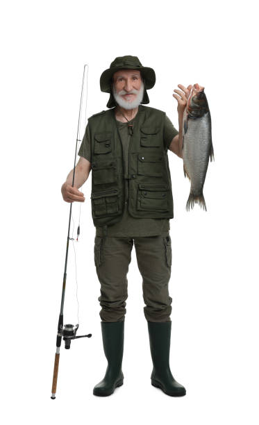 istock Fisherman with rod and catch isolated on white 1950526781