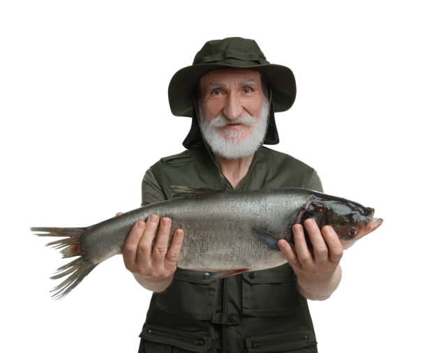 istock Fisherman with caught fish isolated on white 1950527285