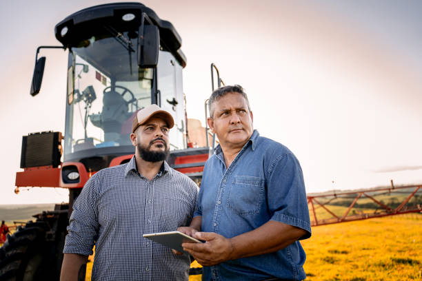 istock Agronomist and farmer in the field with tablet 1950529431