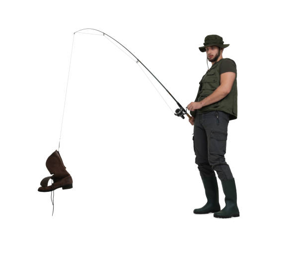 istock Confused fisherman with rod and old boot isolated on white 1950529439