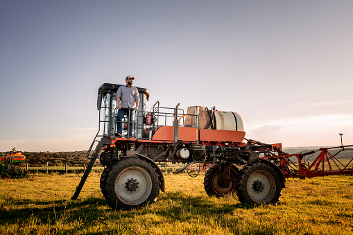 Farmer contemplating the view from above of the agricultural machine