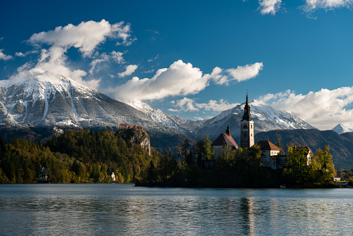 Panoramic view of Lake Bled with Assumption of Maria Church on island on the background of Julian Alps mountains in Slovenia.