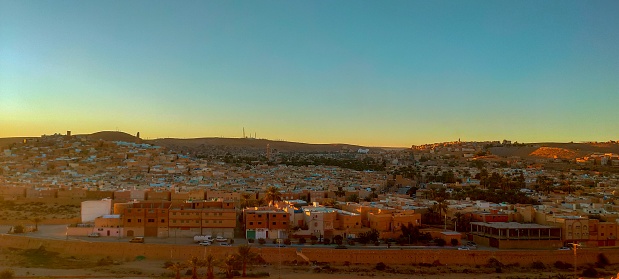 Panoramic view from the highest of the hill on the town of Ghardaia, With its narrow alley, its clay and stone houses at sunset, typical architecture of the sub-Saharan desert, Ghardaïa, M'zab Oasis, Algeria