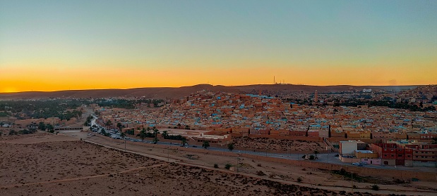 Panoramic view from the highest of the hill on the town of Ghardaia, With its narrow alley, its clay and stone houses at sunset, typical architecture of the sub-Saharan desert, Ghardaïa, M'zab Oasis, Algeria