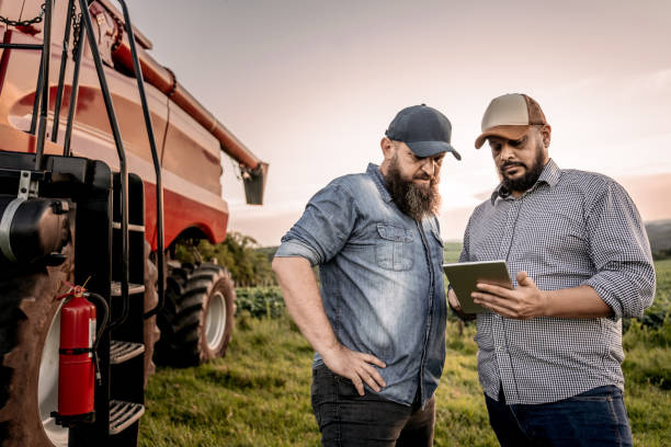 istock Agronomist and farmer in the field with tablet 1950535867