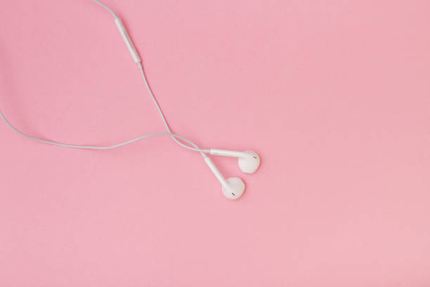 istock White earbuds isolated on a pink background - stock photo 1950577483