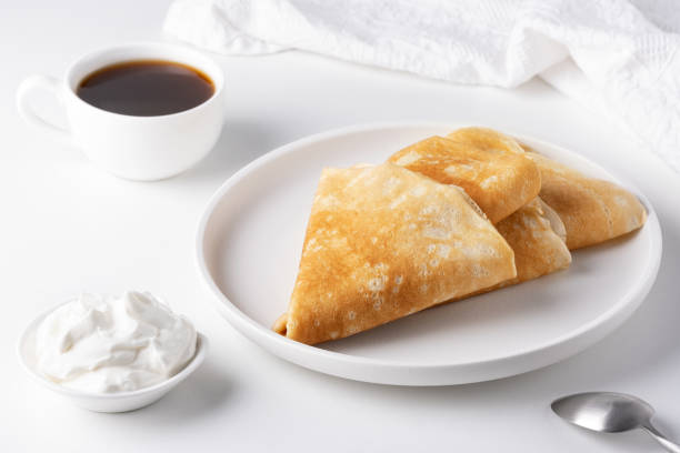istock Thin pancakes in a plate. Concept of delicious breakfast or Maslenitsa 1950583238