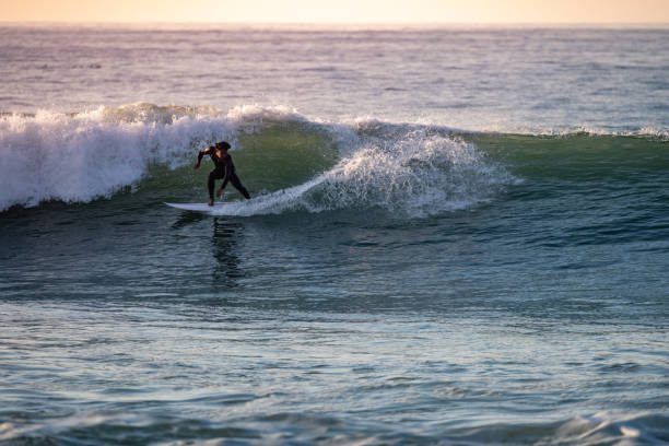 istock Brave teenager making tricks on the rough sea 1950604766