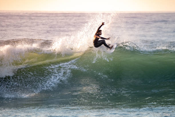 istock Sporty boy riding his surf board 1950605818