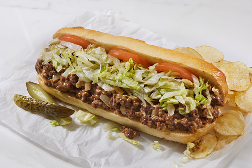 Chopped Cheese Steak Sandwich with Ground Beef, Onions, Cheese Sauce, Shredded Lettuce, Tomato's and Potato Chips